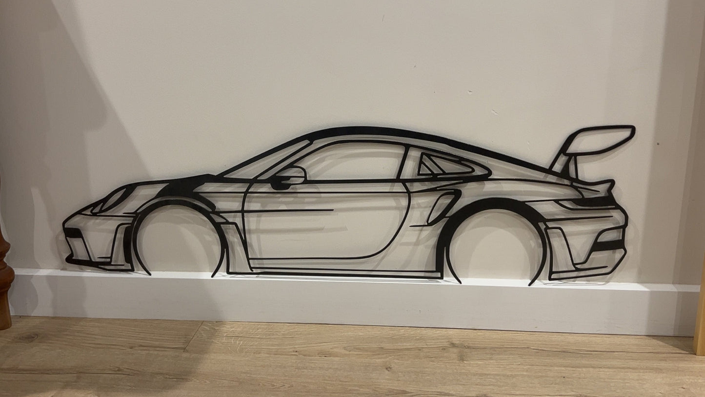 Decorative wall art of a car on a white wall.