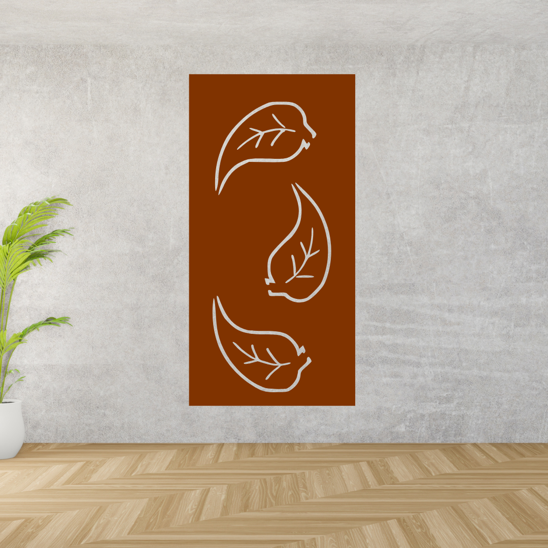 Decorative wall art with leaf designs on a brown background, mounted on a gray wall.