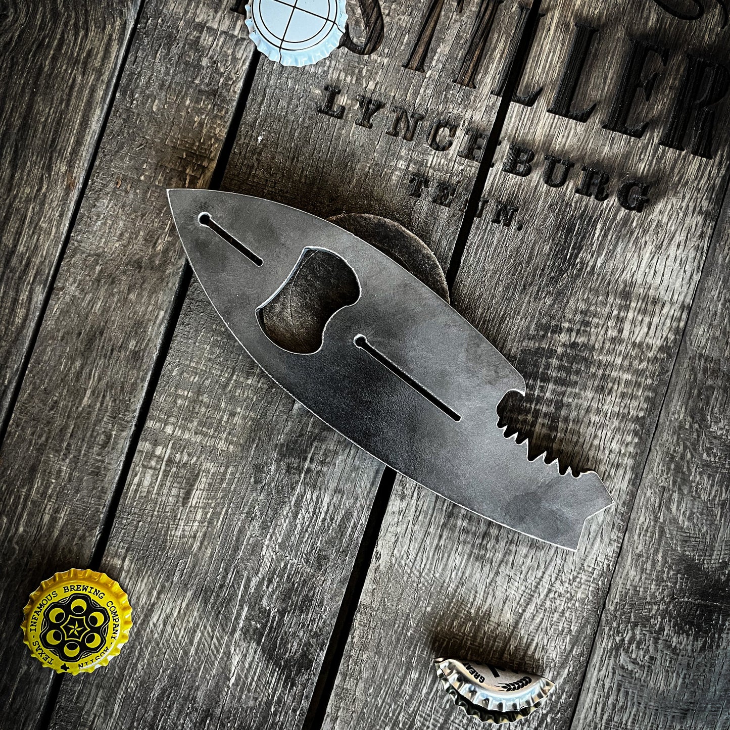 Metal bottle opener on a wooden surface.